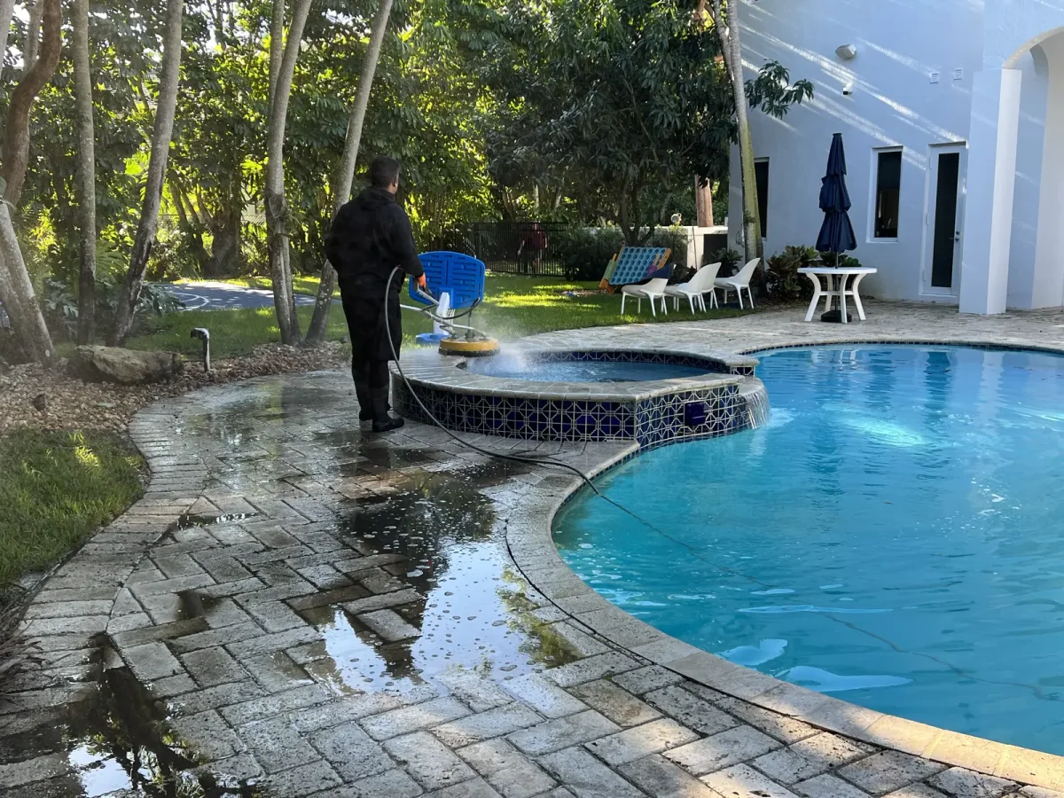 Stone pool surround being cleaned in the documented Pinecrest pressure washing project